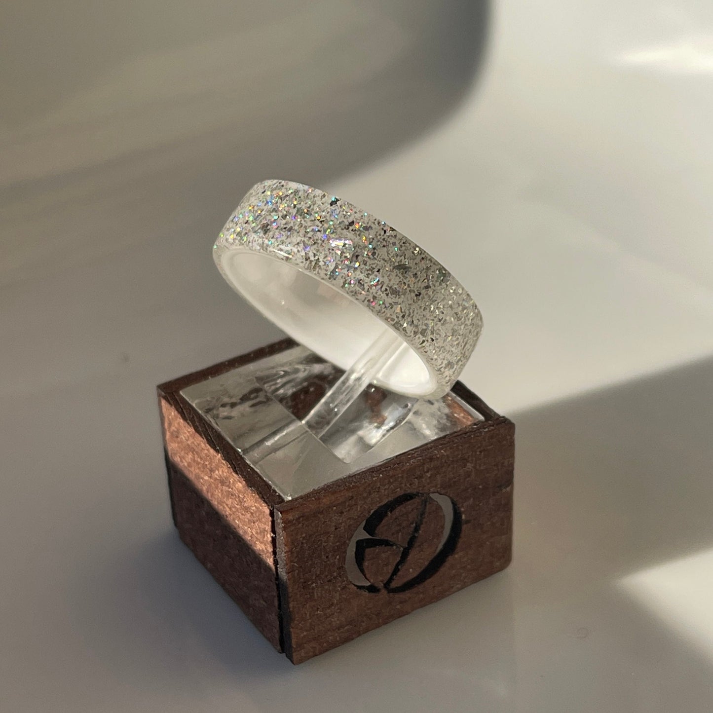 Moissanite DiamondCast Ring on a White Ceramic Band