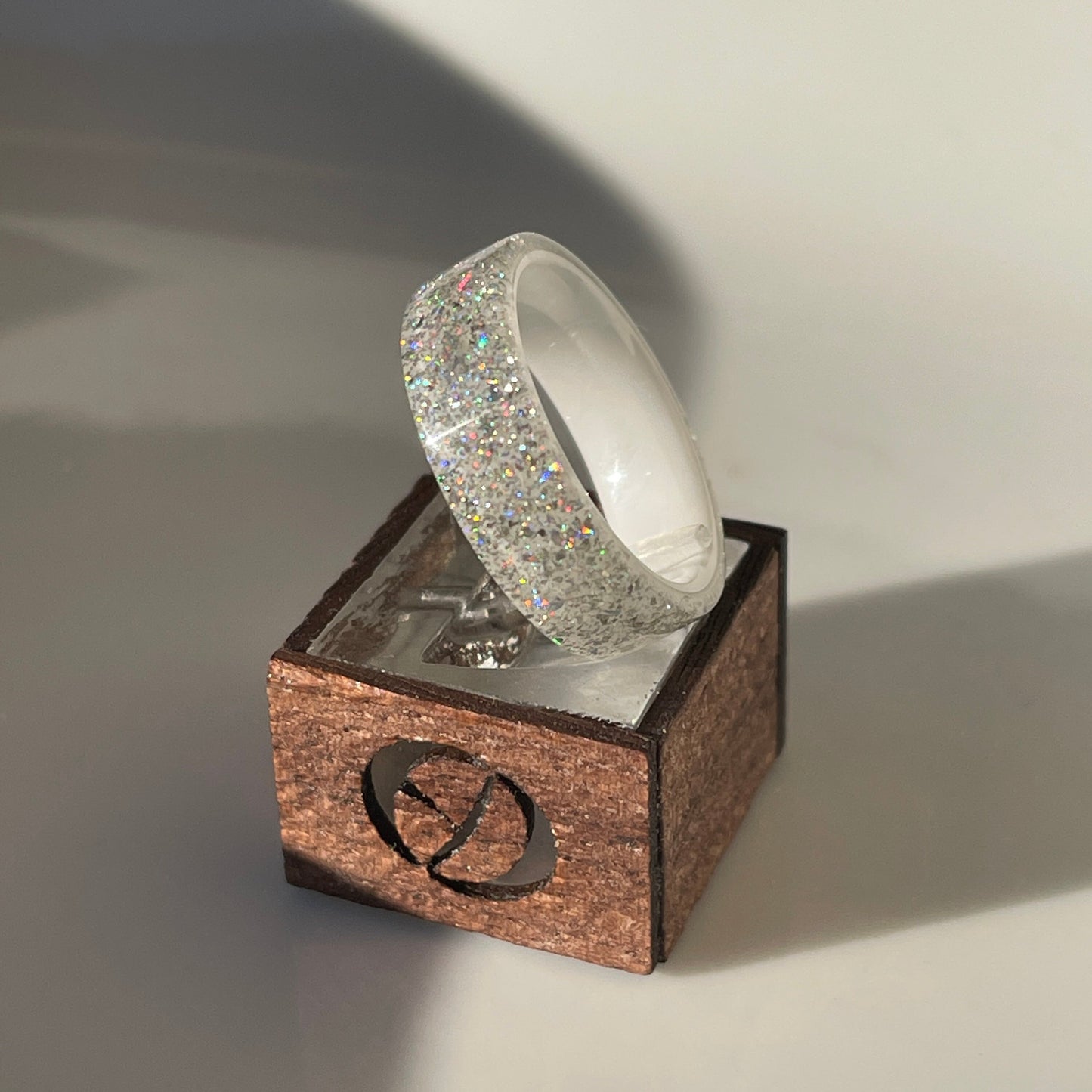 Moissanite DiamondCast Ring on a White Ceramic Band